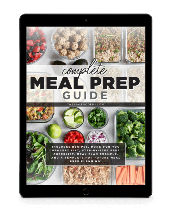 An iPad with image of meal prepped fruit, vegetables, and meals in glass containers on the screen