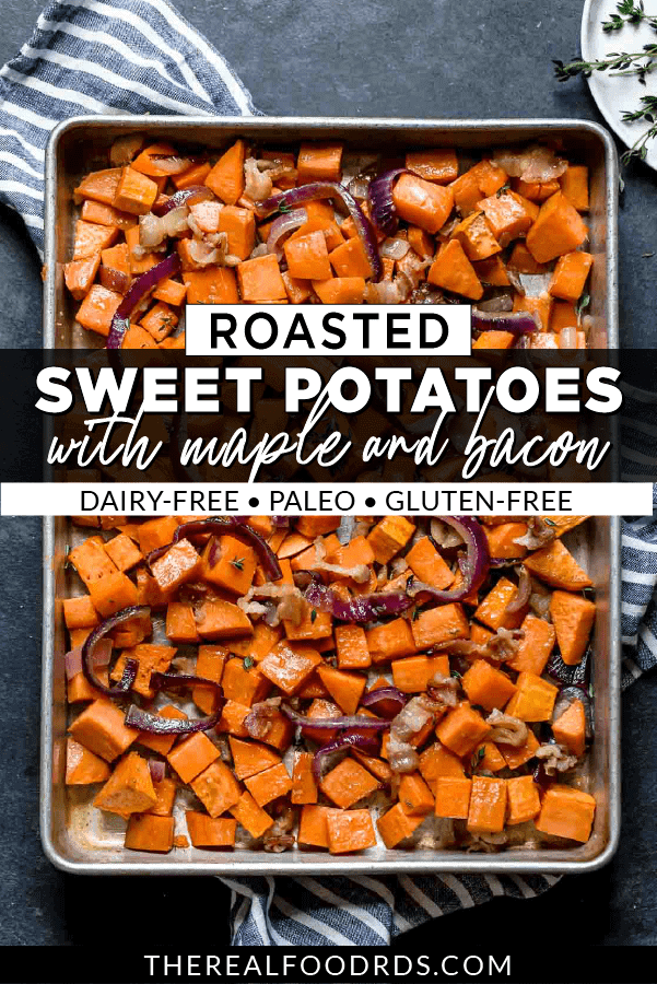 Overhead view of roasted sweet potatoes, red onion, and bacon on a baking sheet.