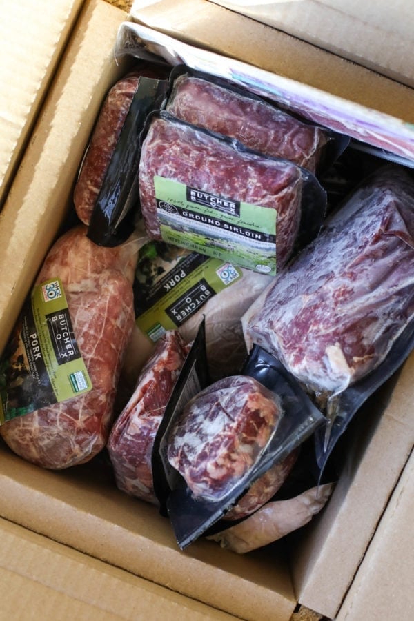 A large box filled with frozen packaged quality meat from ButcherBox.