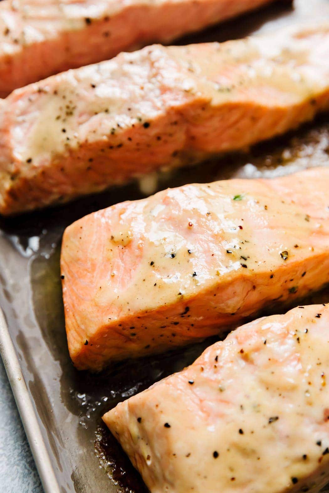 Perfectly baked salmon fillets with caesar dressing baked into the top