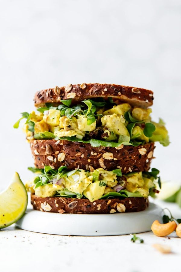 Curry Chicken Salad Recipe served in sandwiches with whole grain bread stacked on top of each other