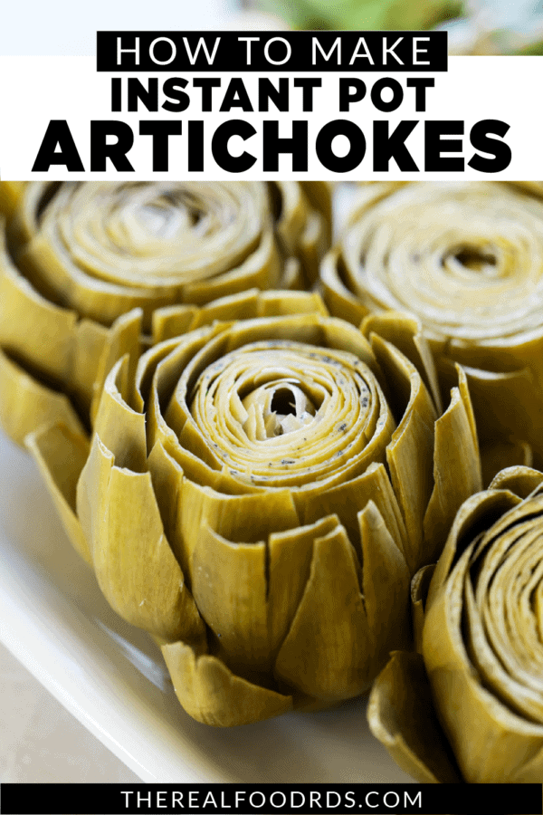 Freshly cooked artichokes on a white platter