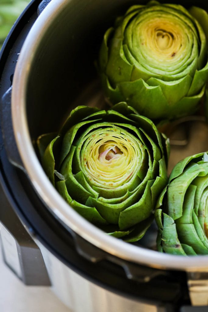 Artichokes placed on the trivet in the Instant Pot