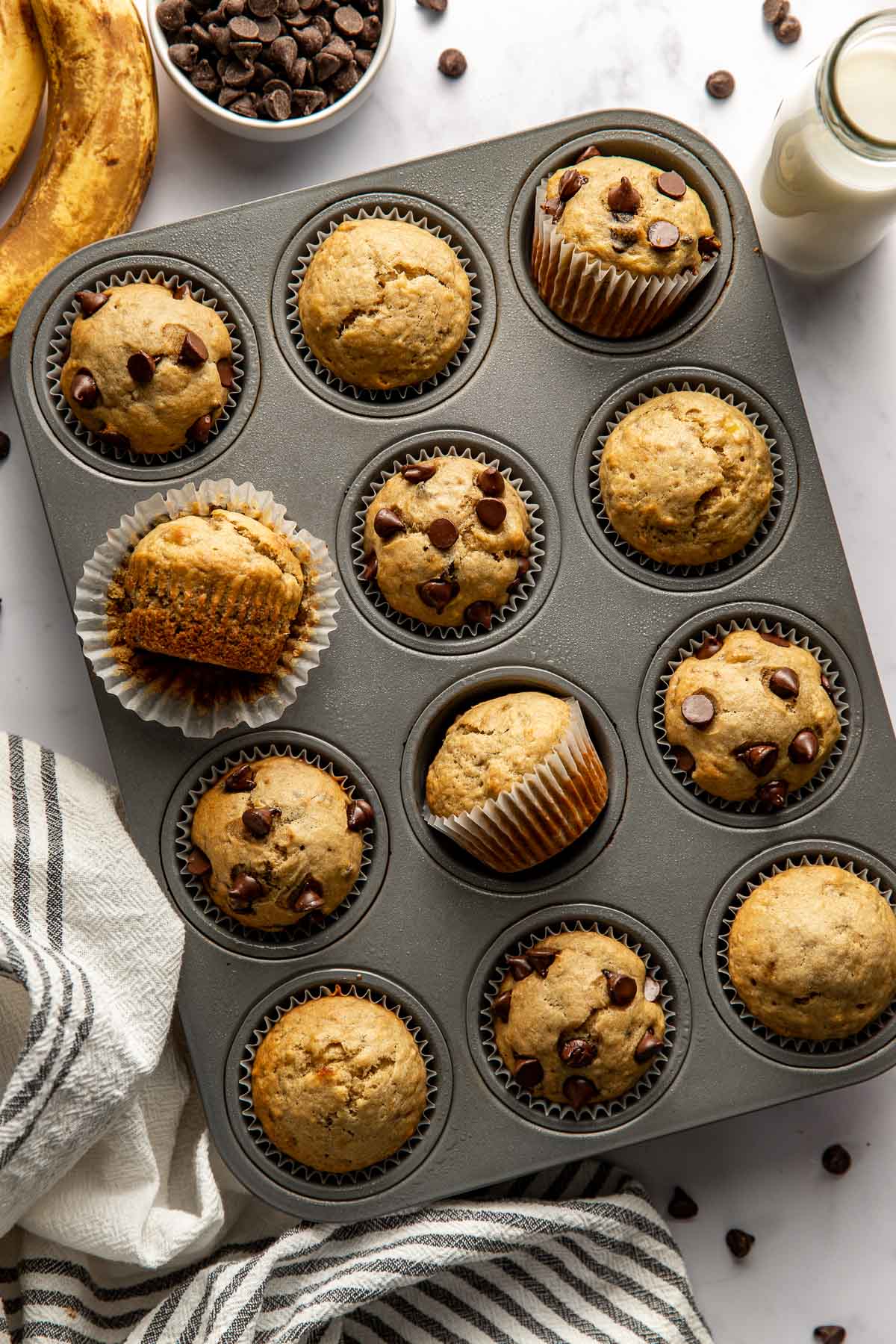 Overhead view of a freshly baked pan of Gluten-Free Banana Muffins topped with chocolate chips.