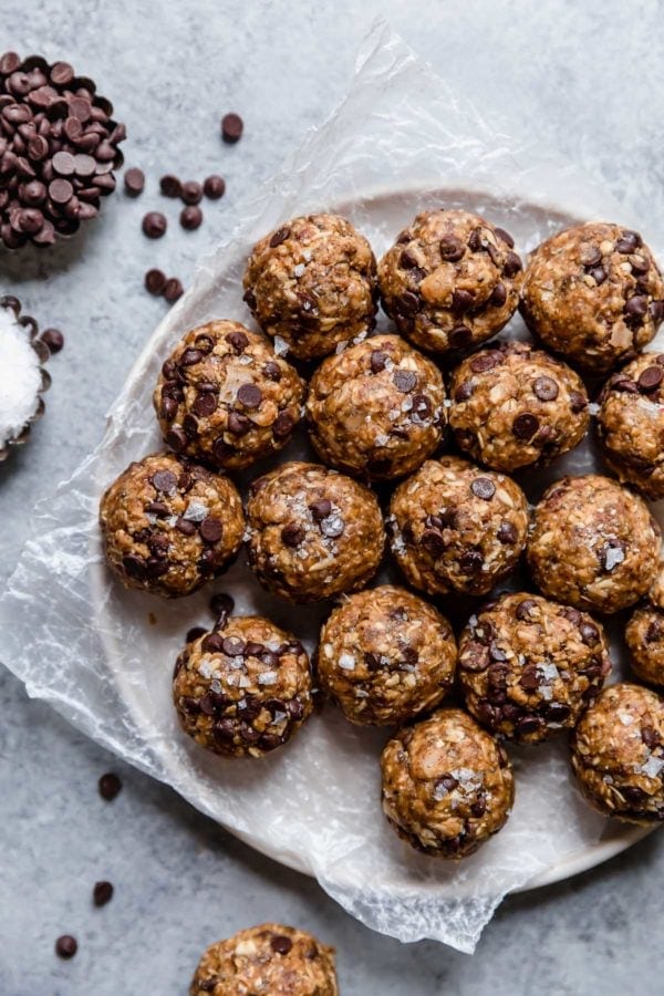 Peanut Butter Oatmeal Balls with chocolate chips on a plate topped with flakey sea salt.
