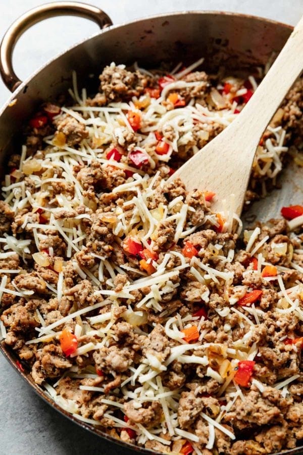 Italian seasoned ground turkey browned and mixed with peppers and mozzarella cheese in a skillet