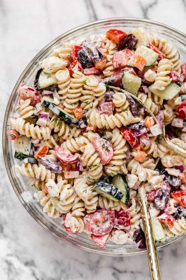 Creamy pasta salad filled with fresh cucumber, tomato, red peppers and fresh dill weed