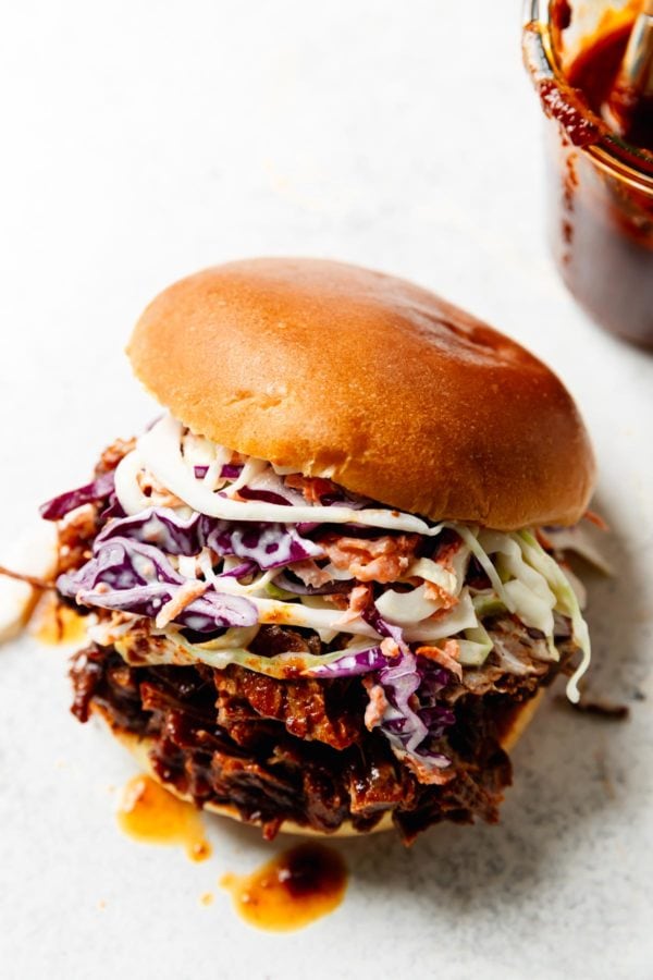 Juicy bbq Instant Pot Brisket in a bun topped with homemade coleslaw