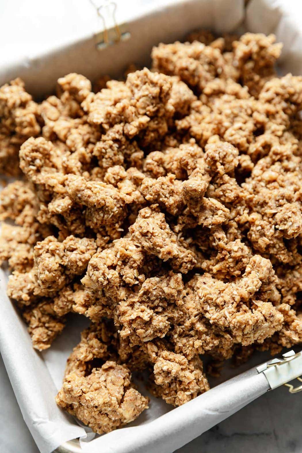 Peanut butter protein bar dough in a baking dish ready to be pressed into bars.