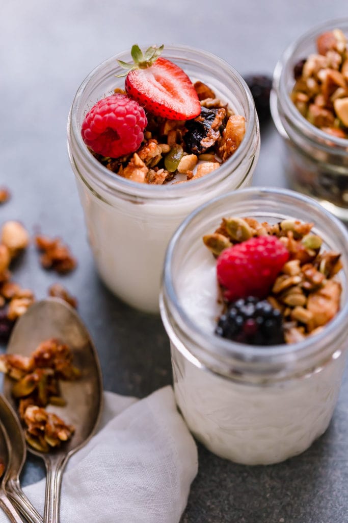 Homemade granola with cinnamon and honey topped on yogurt parfaits