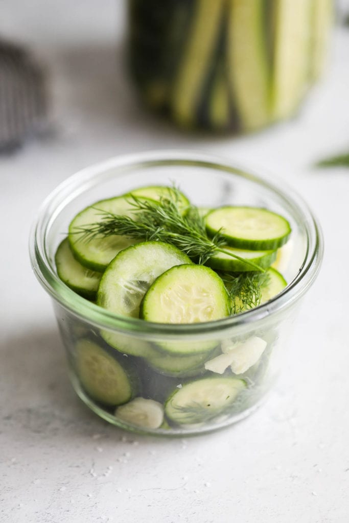 Cucumber slices with fresh dill in a small bowl