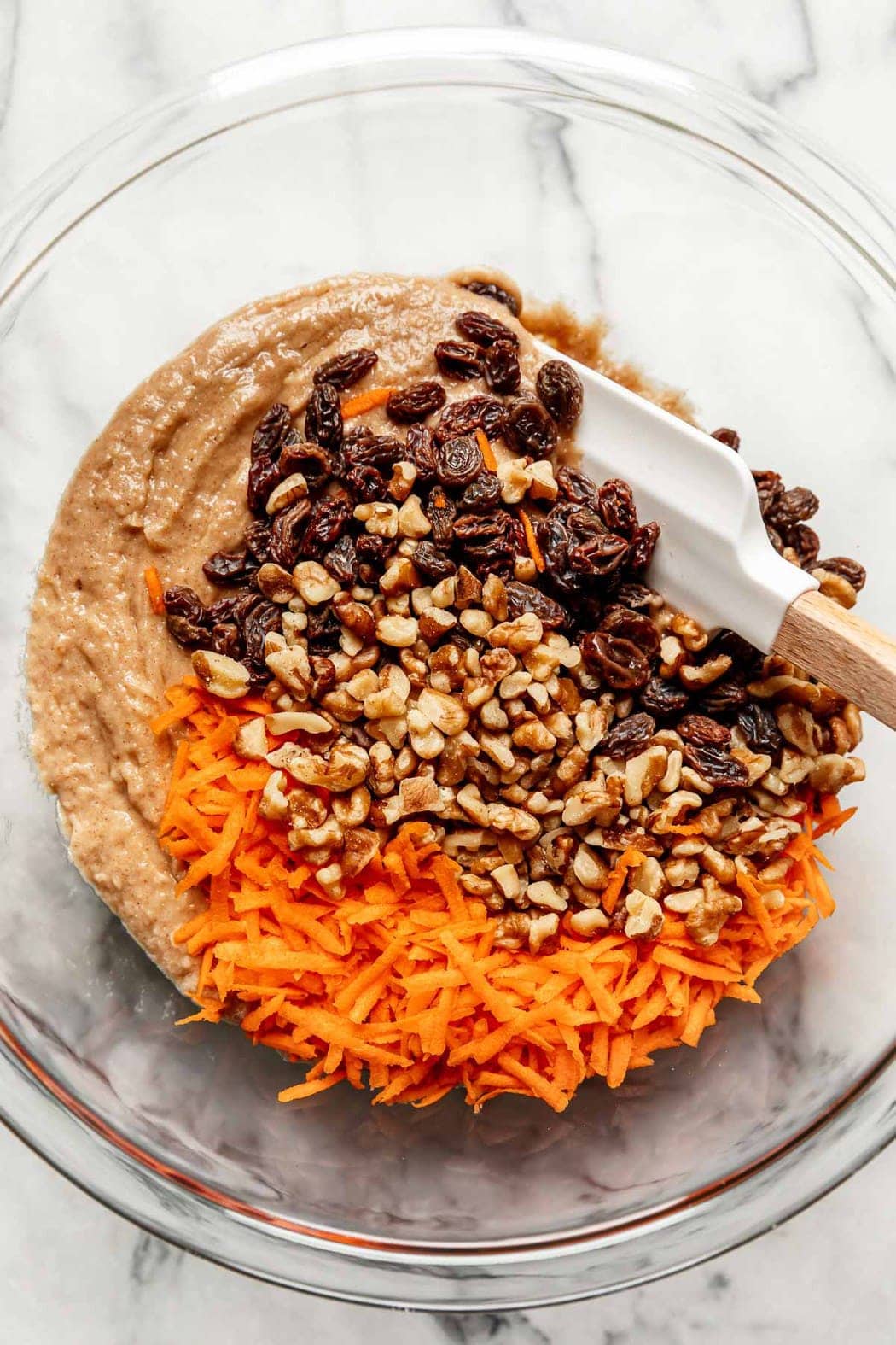 All ingredients for healthy carrot cake in a mixing bowl