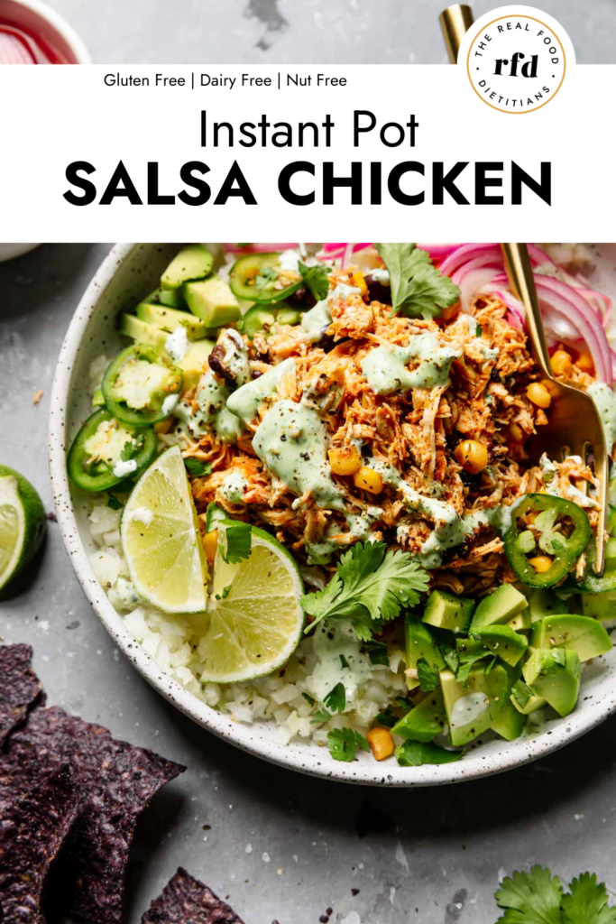 Stone bowl filled with instant pot salsa chicken served over rice and lettuce