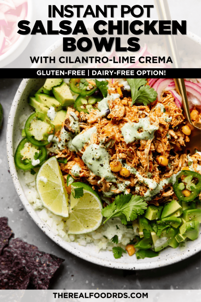 Instant pot shredded salsa chicken in a bowl served on top of cauliflower rice, mixed greens, avocado, and cilantro-lime dressing