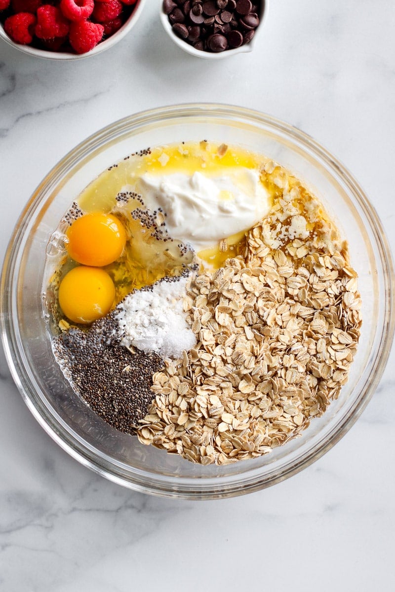 All ingredients for baked oatmeal in a mixing bowl ready for mixing together