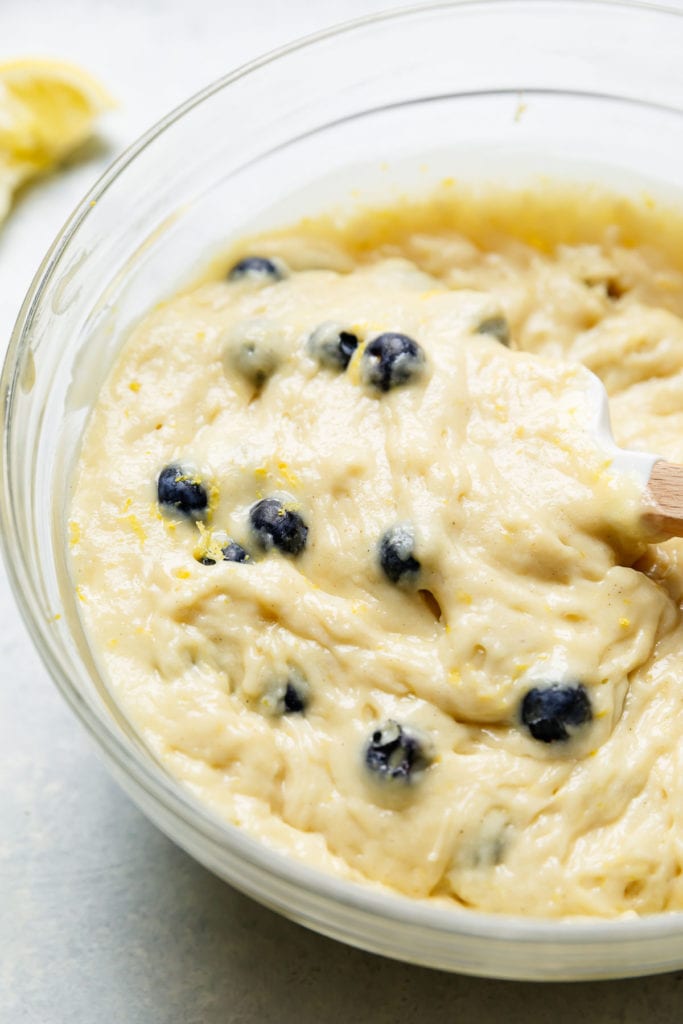 Lemon blueberry loaf batter in a clear mixing bowl