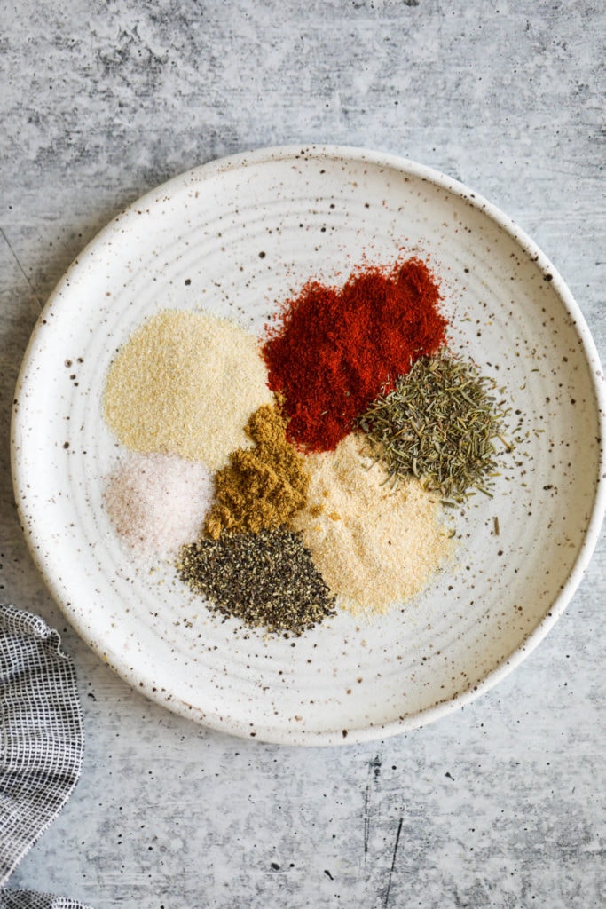 All spices for smoked spatchcock chicken on a small plate