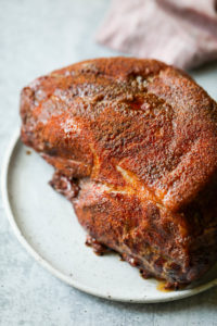 Seasoned smoked pork butt on a serving plate
