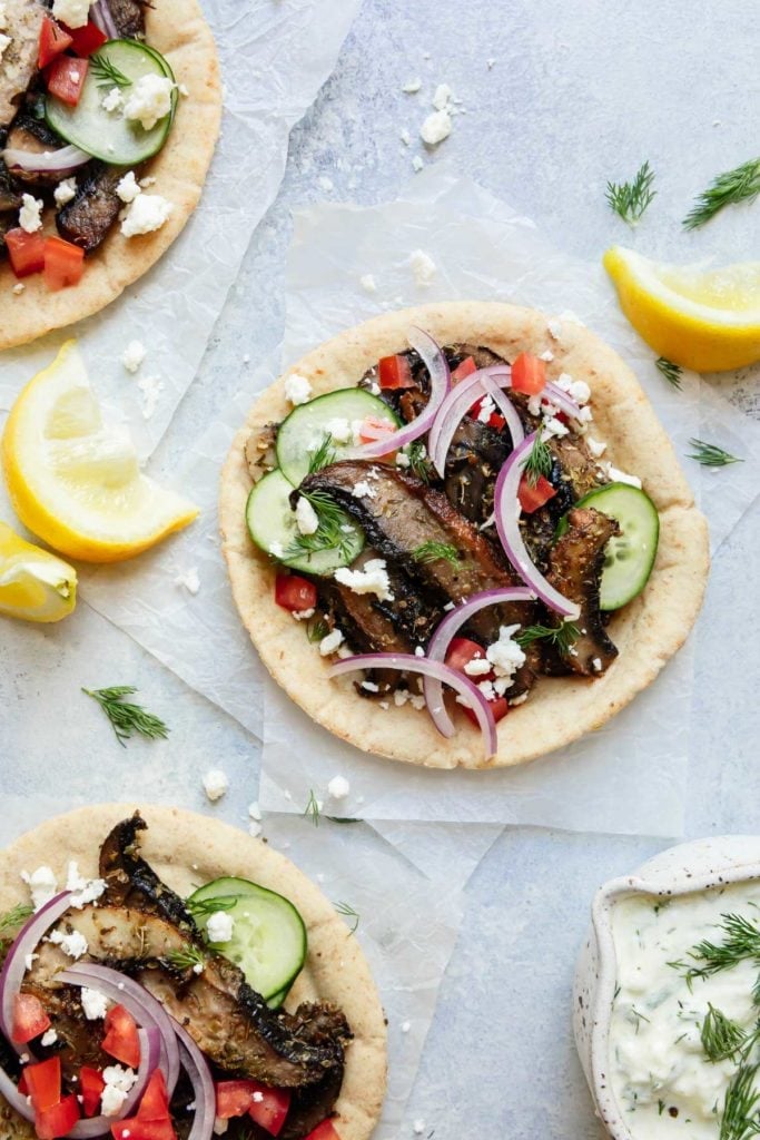 Overhead view of a gluten-free pita filled with portobello mushrooms slices and gyro toppings.