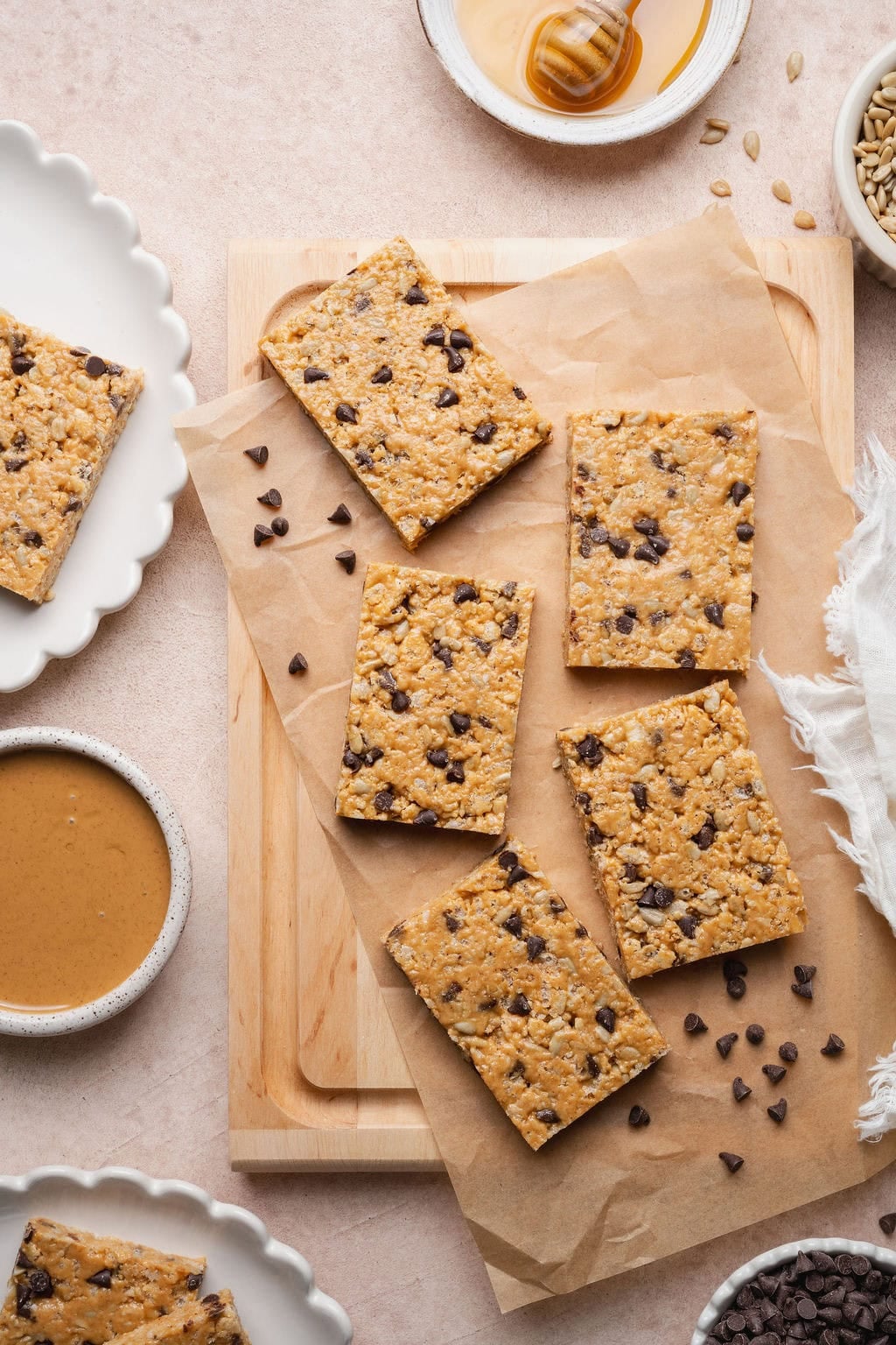 Five homemade Clif bars on a wooden cutting board.