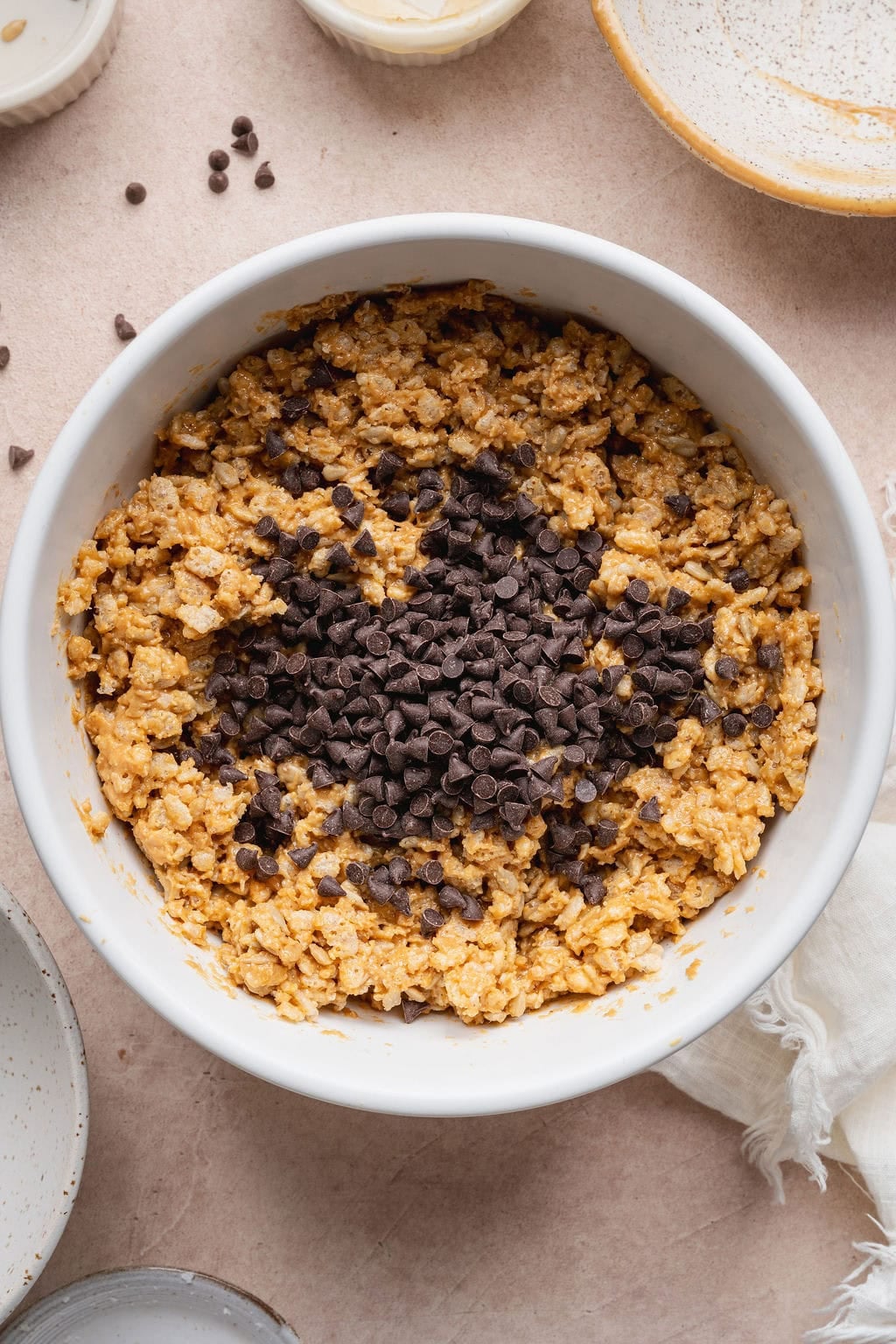 Chocolate chips on top of homemade Clif bar ingredients in a bowl.