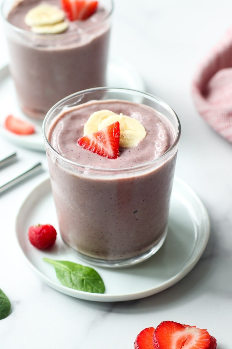 A freshly made berry blast smoothie in a short clear cup