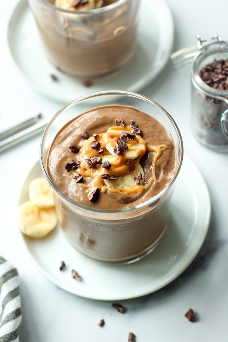 Freshly made chocolate banana smoothie in a short clear cup