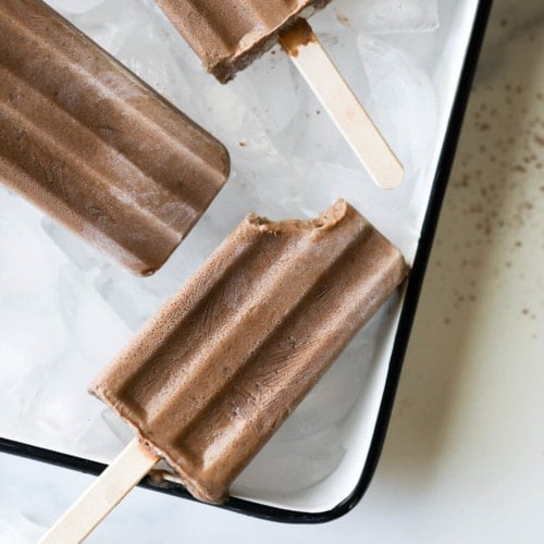 Quick and easy dairy free fudgesicles with a bite taken from one corner