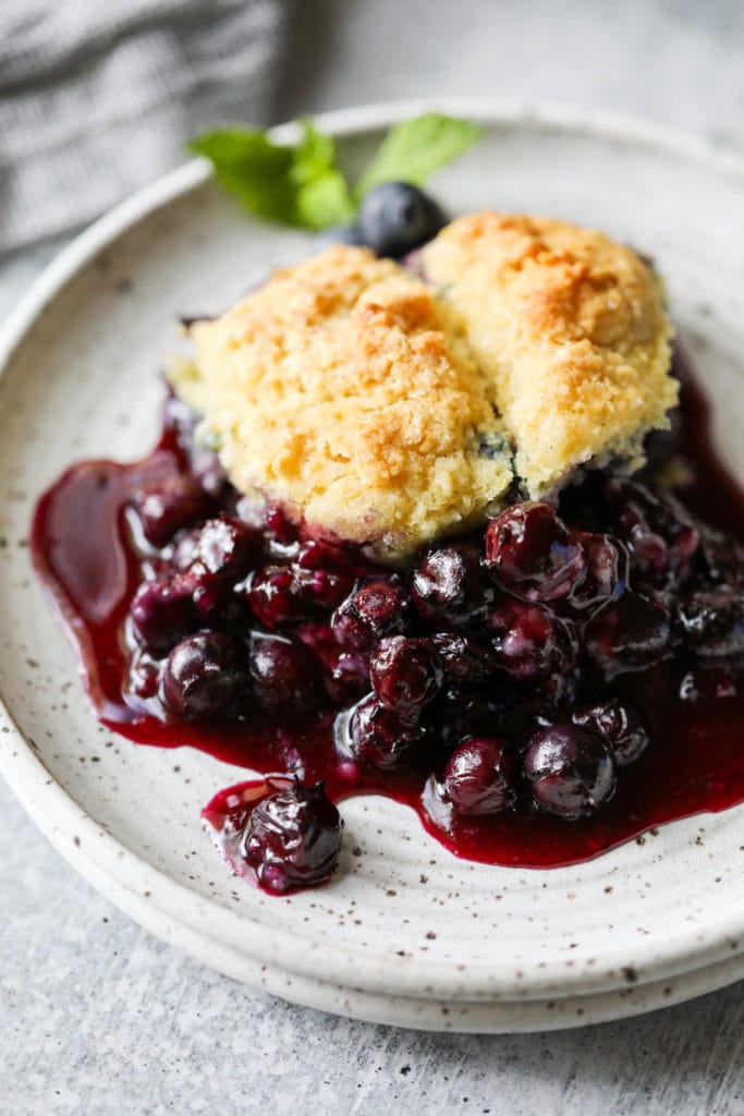 Serving of blueberry cobbler on stone plate 