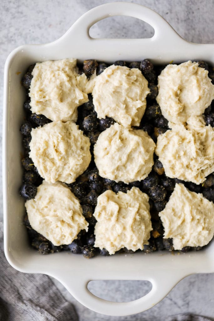 Overhead view blueberry cobbler topped with biscuit dough dollops