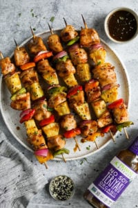 Teriyaki chicken kebabs with pineapple and peppers on skewers plated ready for serving
