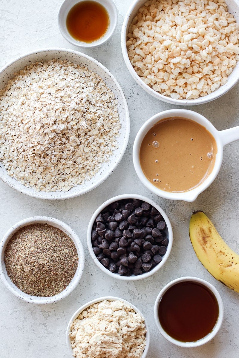 All ingredients for vegan protein bars in small bowls and measuring cups