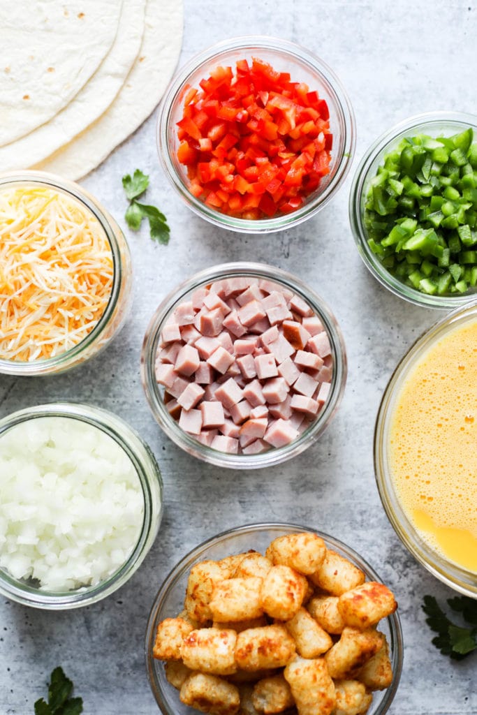 All ingredients for Denver Omelet Breakfast Burrito in small glass containers