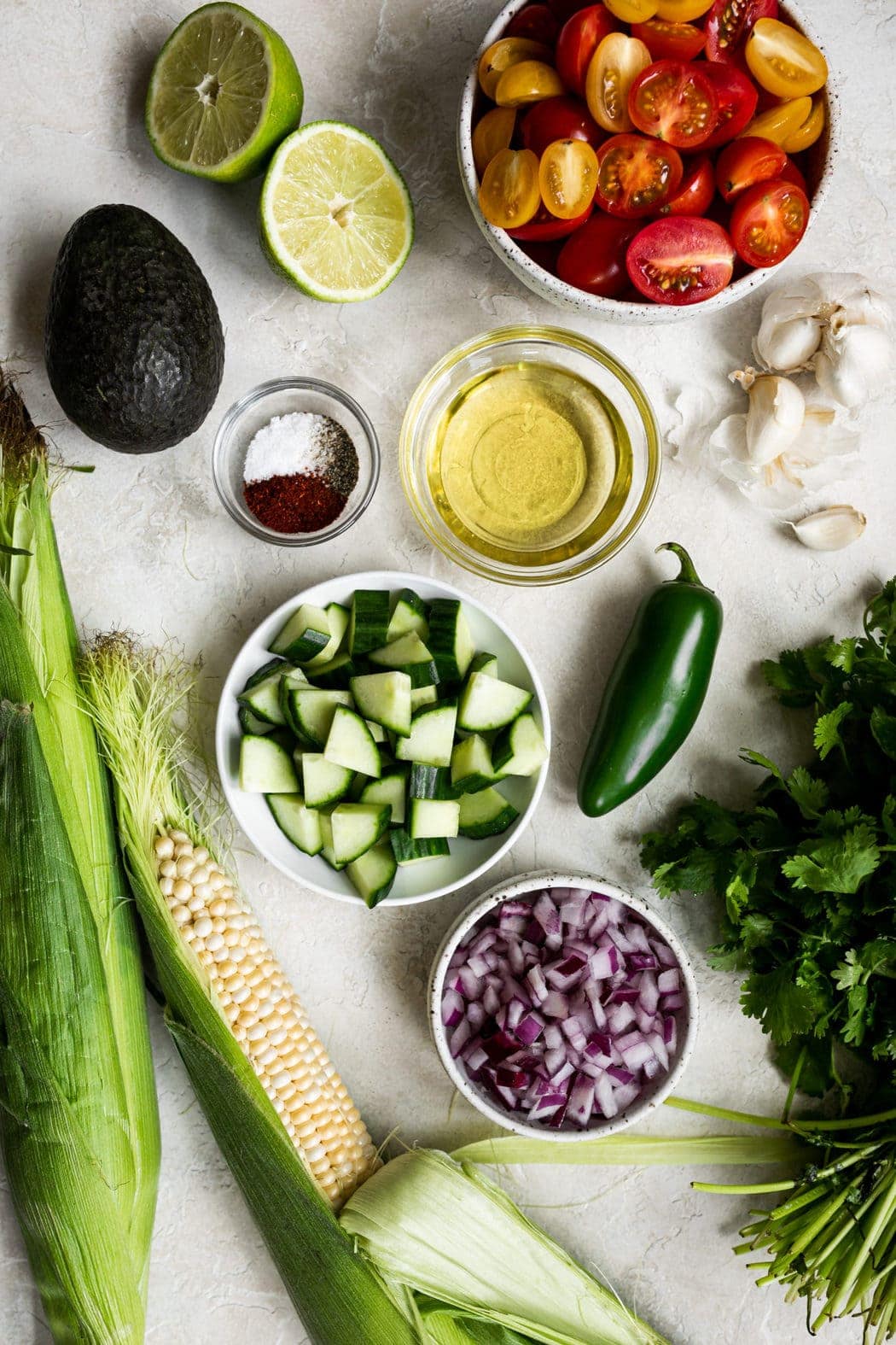 All ingredients for summer corn salad on a counter