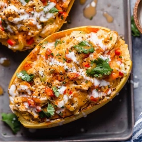 Overhead view of buffalo chicken stuffed spaghetti squash topped with blue cheese and ranch dressing