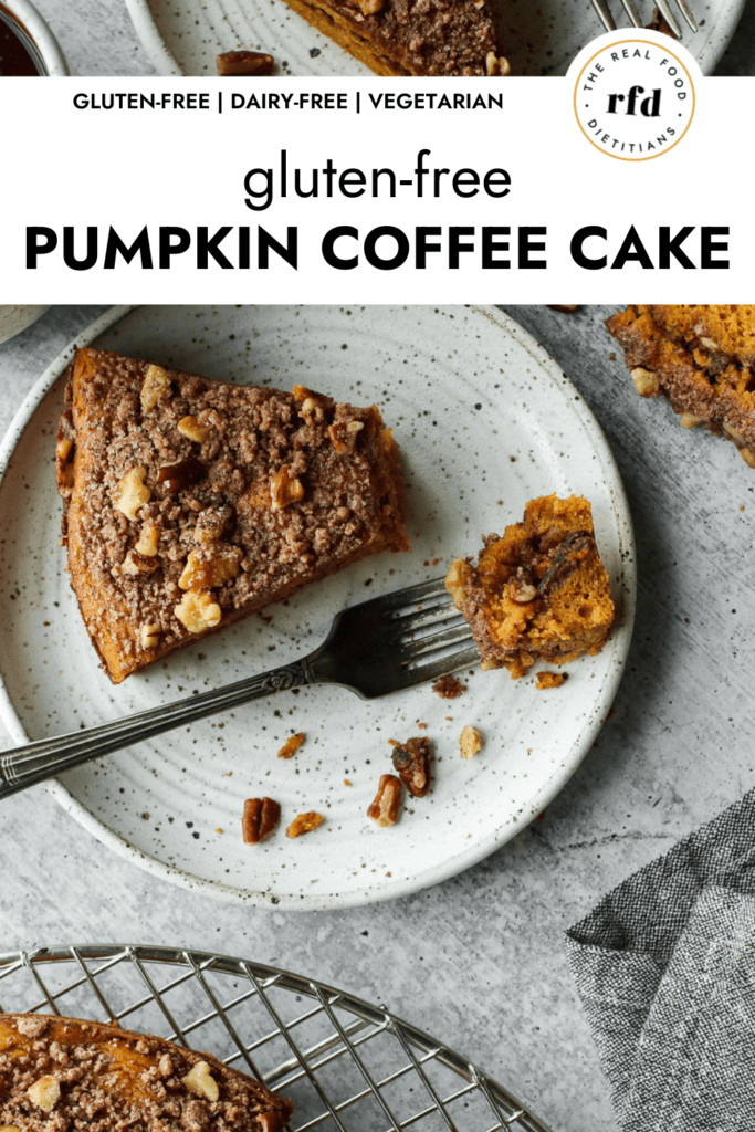 An overhead view of gluten-free pumpkin coffee cake topped with pecans and crumble plated on a speckled plate with a fork filled with a helping of coffee cake.