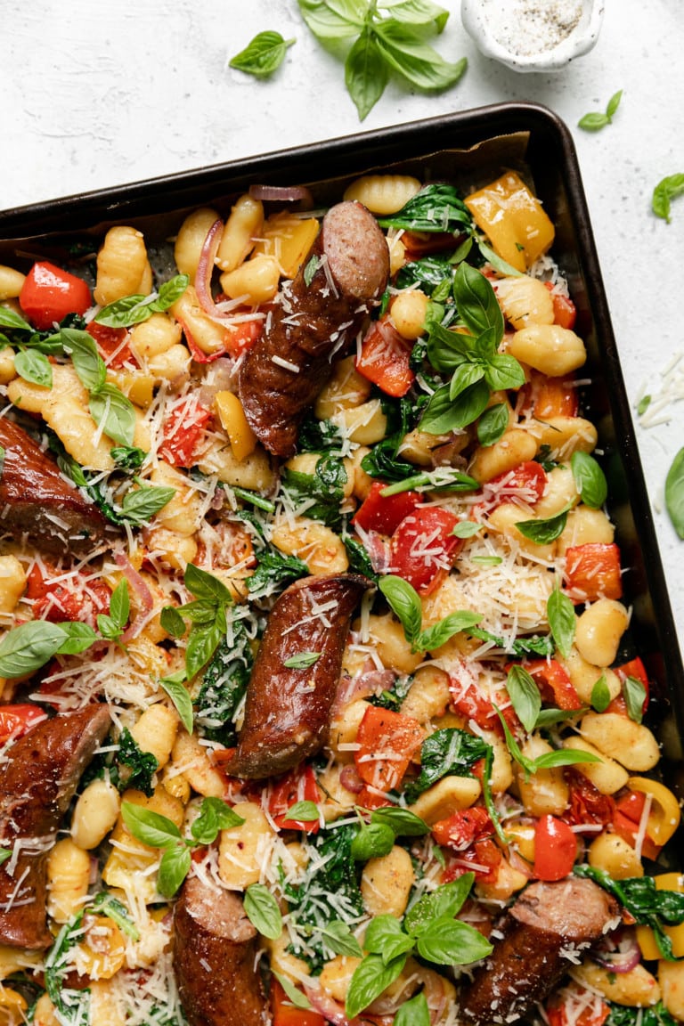 Overhead view of sheet pan gnocchi with kielbasa and vegetables. 
