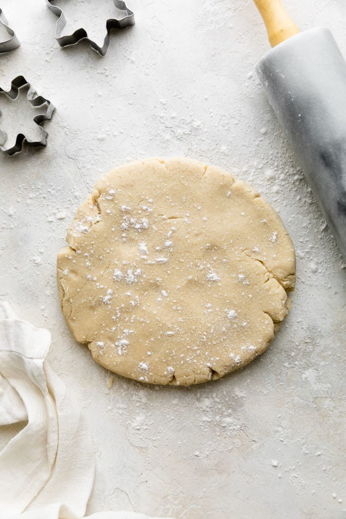 Sugar cookie dough pressed into a disc ready to rolling out.