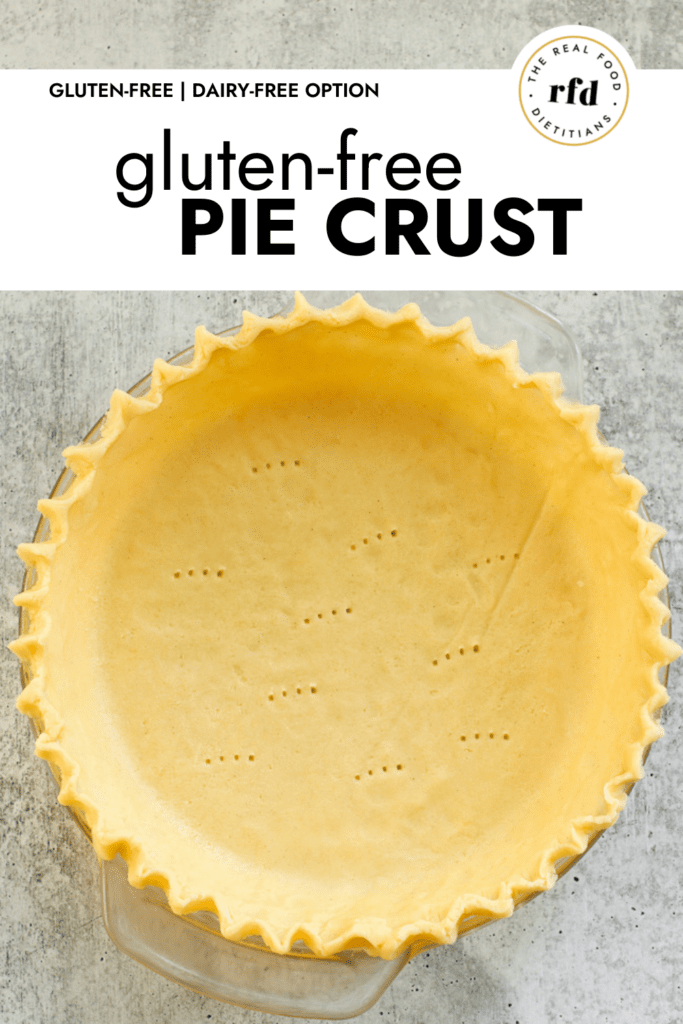 Overhead view of gluten-free pie crust in a glass pie plate with fluted edges and fork marks on the bottom of the pie.