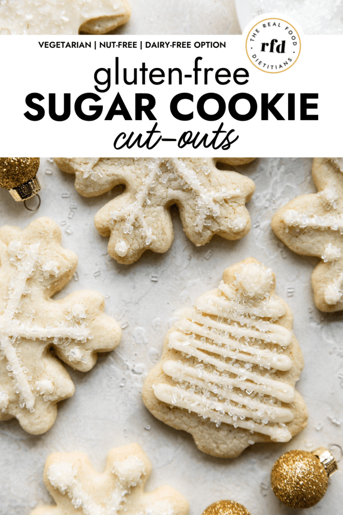 Gluten-Free sugar cookies cut out in Christmas trees and snowflakes with minimal white piping arranged together.