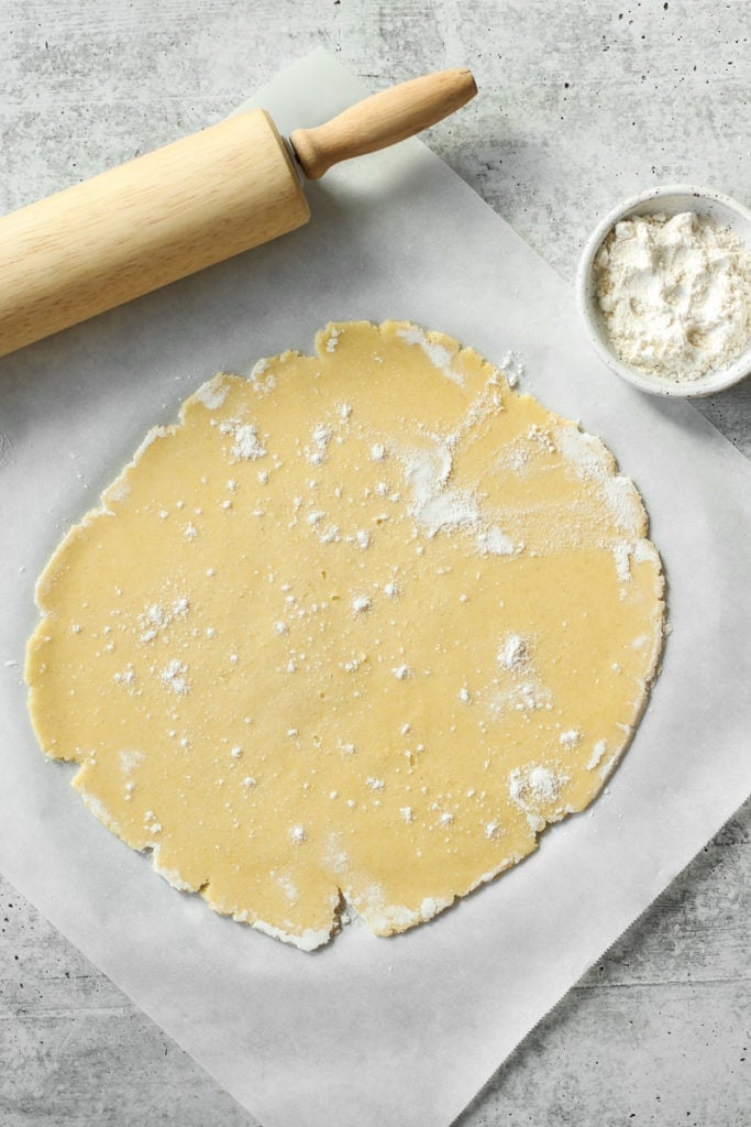 Gluten-Free pie crust rolled out with flour sprinkled on top