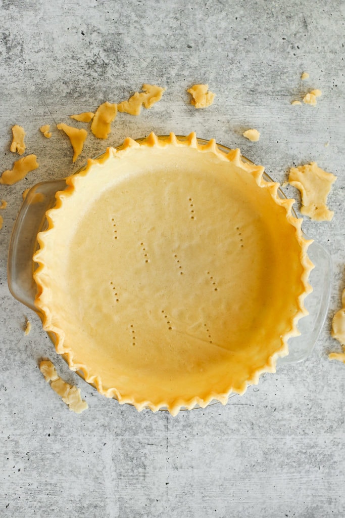 A gluten-free pie crust in a pie plate with fluted edges