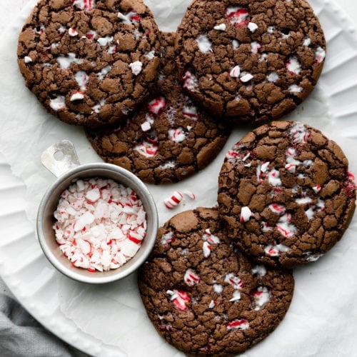 Several gluten-free peppermint brownie cookies on a white platter