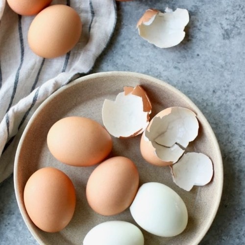 Overhead view of hard boiled farm-fresh eggs in a low profile bowl.