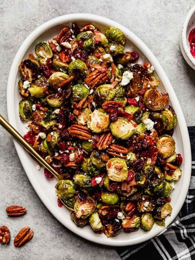 Overhead view white serving platter filled with Roasted Brussels Sprouts with bacon and balsamic.