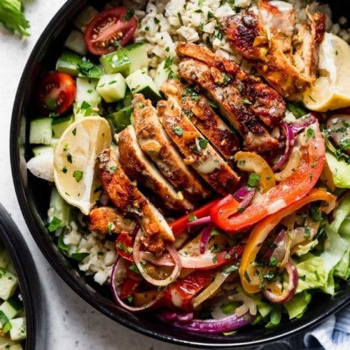 Overhead view of a chicken shawarma bowl with cilantro-lime dressing.