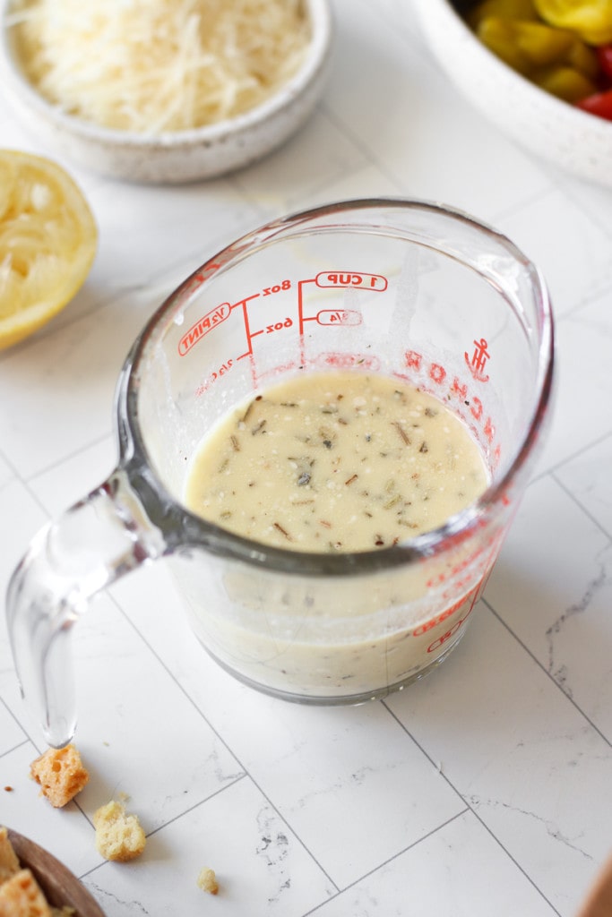 Creamy Italian Dressing for copycat Olive Garden Salad in a measuring cup.