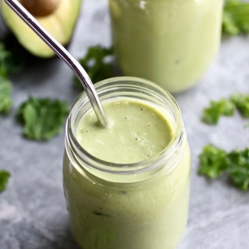 A 5-ingredient go-to green smoothie in a mason jar with a metal straw.