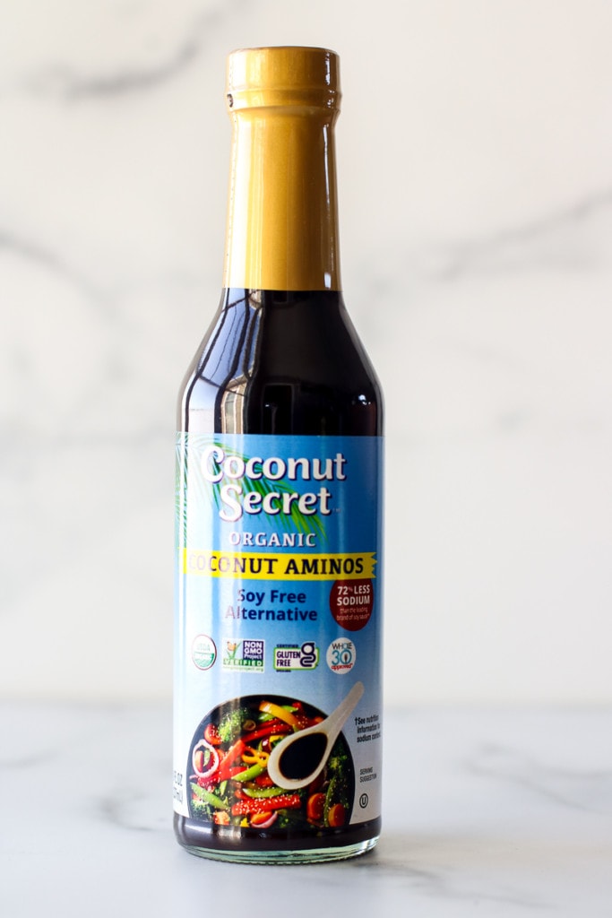 A glass bottle of Coconut Secret coconut aminos