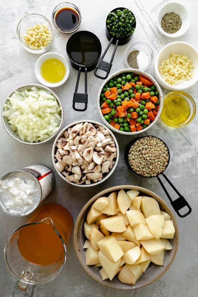 All ingredients for vegan shepherd's pie arranged together in bowls and measuring cups.